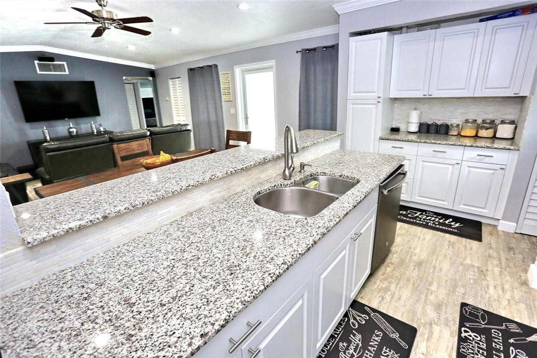 6960 Southwest 1st Street Margate, FL 33068 - Photo 18 of 36 a kitchen with a sink a counter top space appliances and cabinets