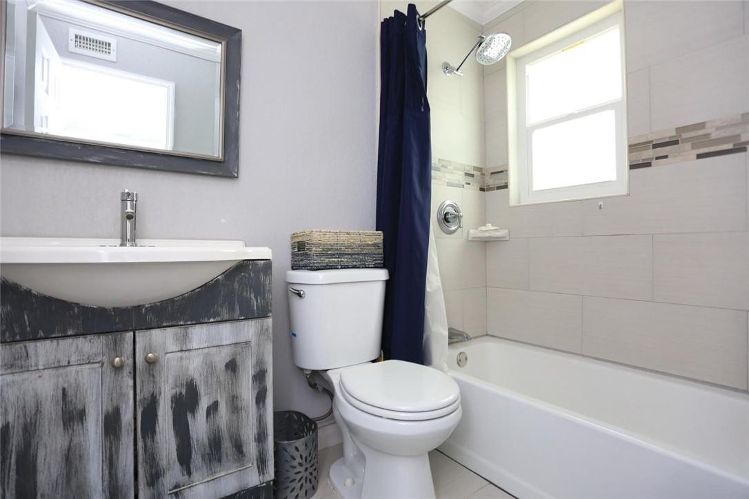 6960 Southwest 1st Street Margate, FL 33068 - Photo 21 of 36 a bathroom with a sink a toilet a mirror and bathtub