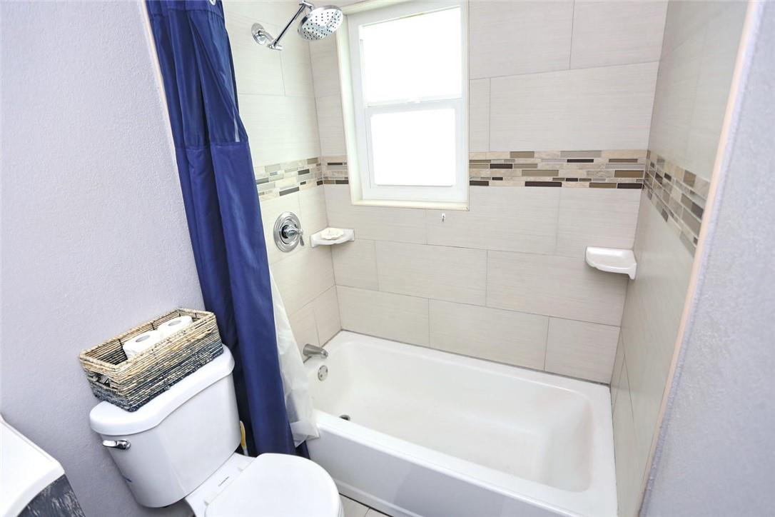 6960 Southwest 1st Street Margate, FL 33068 - Photo 22 of 36 a bathroom with a granite countertop bathtub shower and toilet