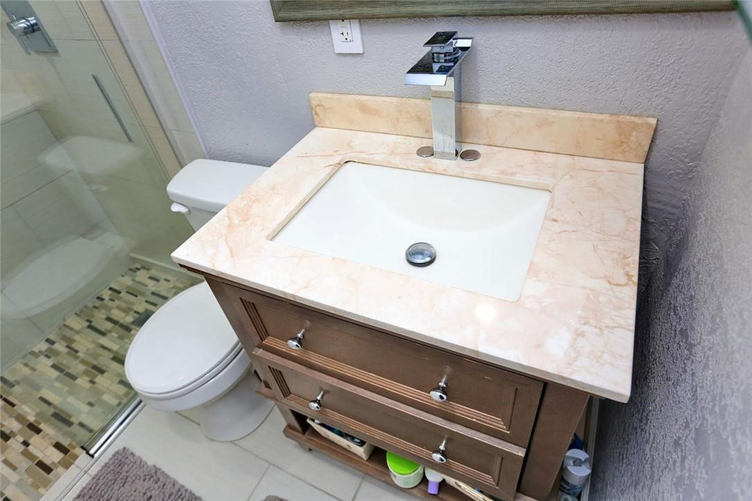 6960 Southwest 1st Street Margate, FL 33068 - Photo 27 of 36 a bathroom with a sink and a toilet