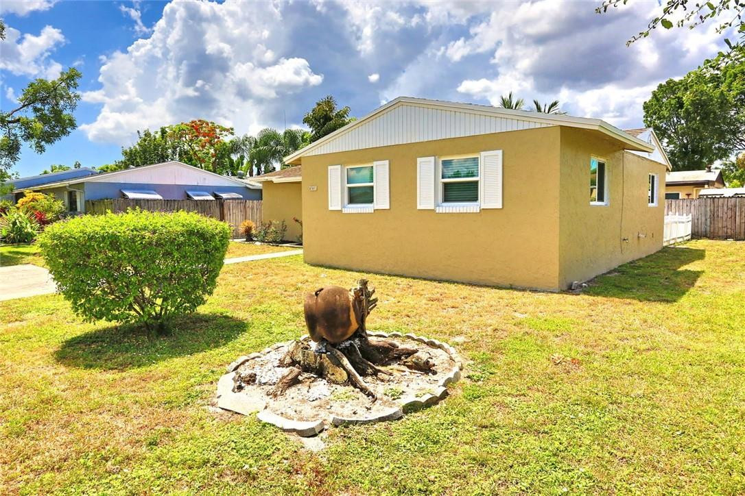 6960 Southwest 1st Street Margate, FL 33068 - Photo 5 of 36 a blue swimming pool with a yard in the background