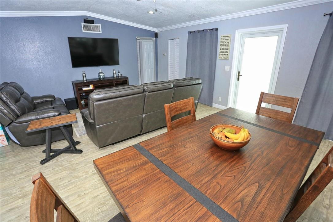 6960 Southwest 1st Street Margate, FL 33068 - Photo 7 of 36 a living room with furniture and a flat screen tv
