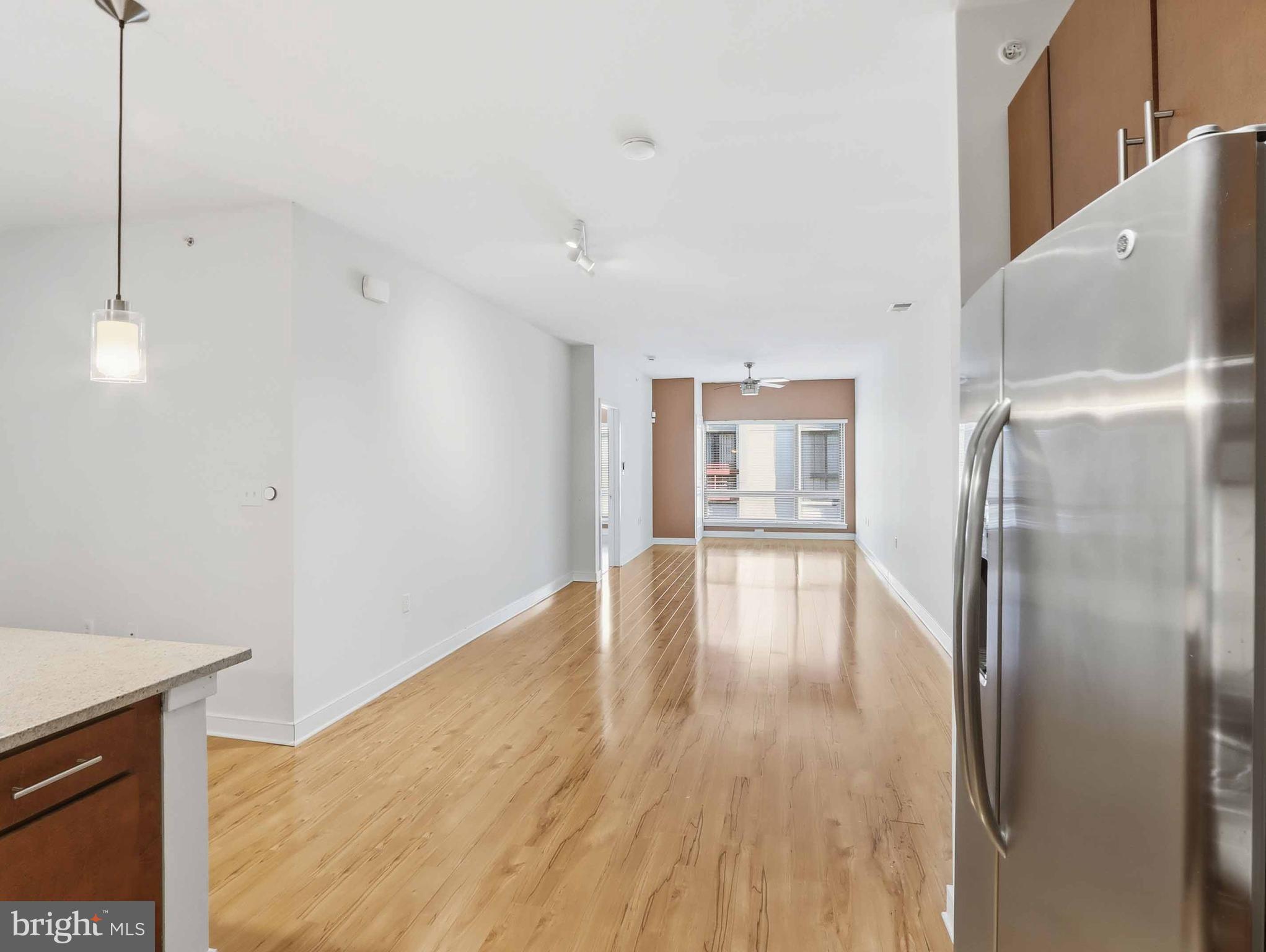 8005 13th Street, Unit 411 Silver Spring, MD 20910 - Photo 25 of 33 a view of empty room with wooden floor and fan