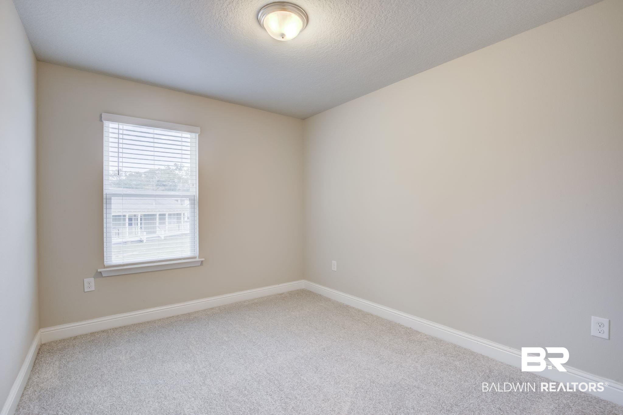 25806 Pollard Road, Unit 60 Daphne, AL 36526 - Photo 27 of 35 Unfurnished room with carpet and a textured ceiling