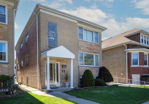 5705 West Higgins Avenue, Unit 2 Chicago, IL 60630 - Photo 1 of 12 front view of a house with a yard