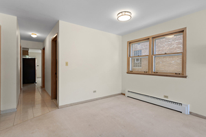 5705 West Higgins Avenue, Unit 2 Chicago, IL 60630 - Photo 3 of 12 an empty room with windows and closet