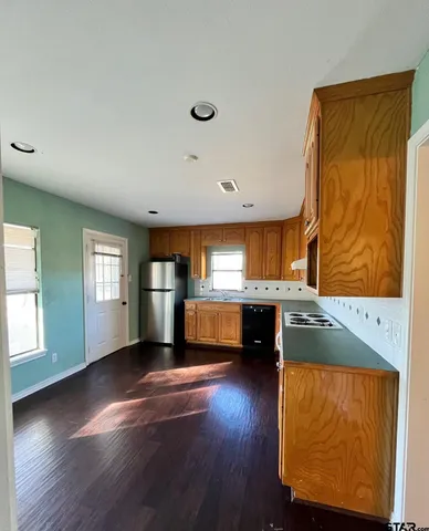 a view of an empty room with closet and a window