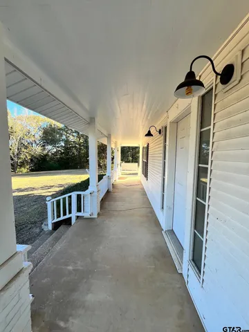 a view of a porch with furniture and front door