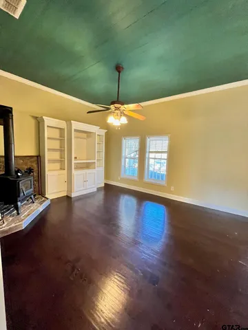 an empty room with wooden floor and a window