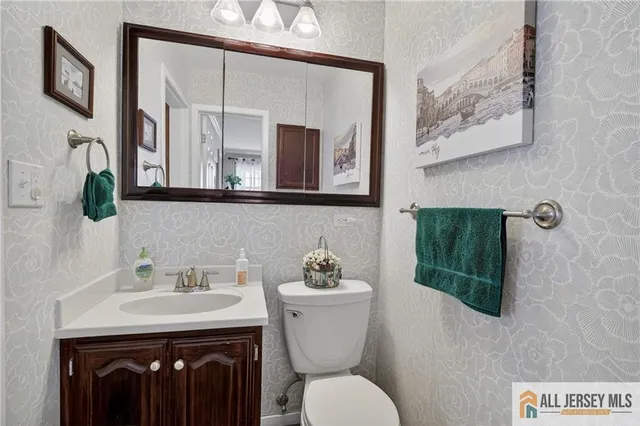 a bedroom with two separate beds and two window