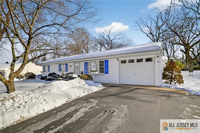 a view of a house with a yard covered in snow