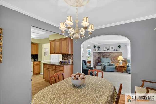 a kitchen with granite countertop stainless steel appliances a sink a stove cabinets and a counter top space