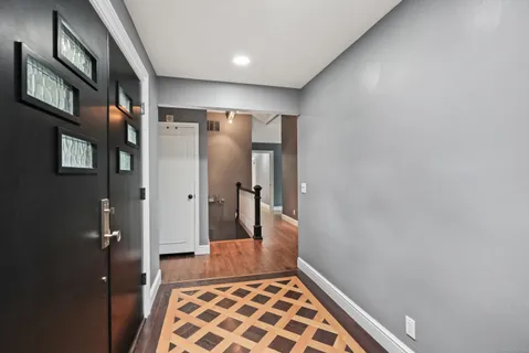 a view of hallway with a large window and glass door