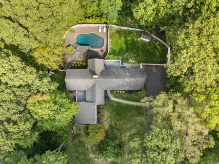 an aerial view of a house with yard swimming pool and outdoor seating