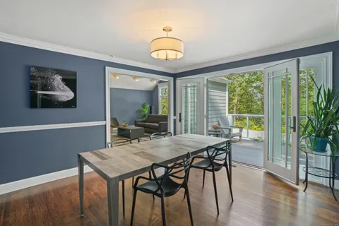 a view of a dining room with furniture window and wooden floor