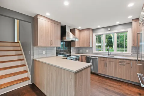 a kitchen with a sink stove and cabinets