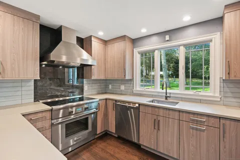 a kitchen with a stove sink and microwave