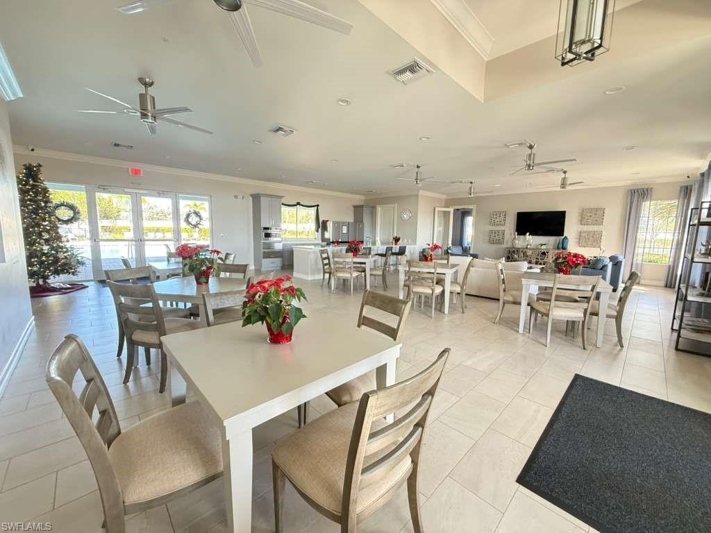 1059 Enbrook Loop Naples, FL 34114 - Photo 4 of 19 Dining space featuring ornamental molding, ceiling fan, light tile patterned floors, and healthy amount of natural light
