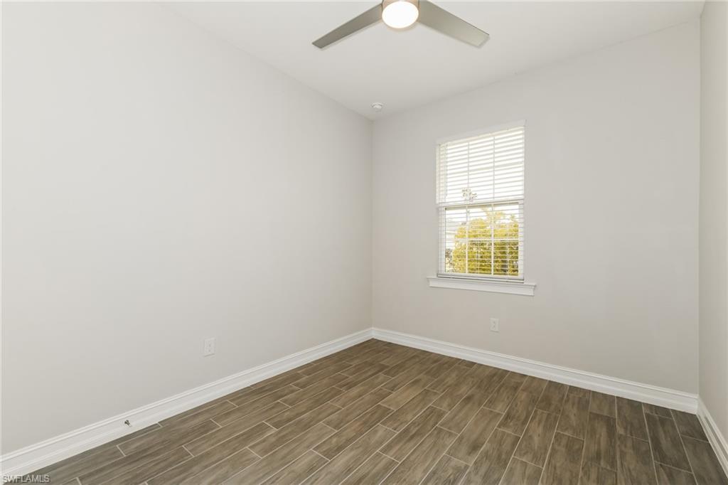 1059 Enbrook Loop Naples, FL 34114 - Photo 9 of 19 Spare room with wood tiled floors and a ceiling fan