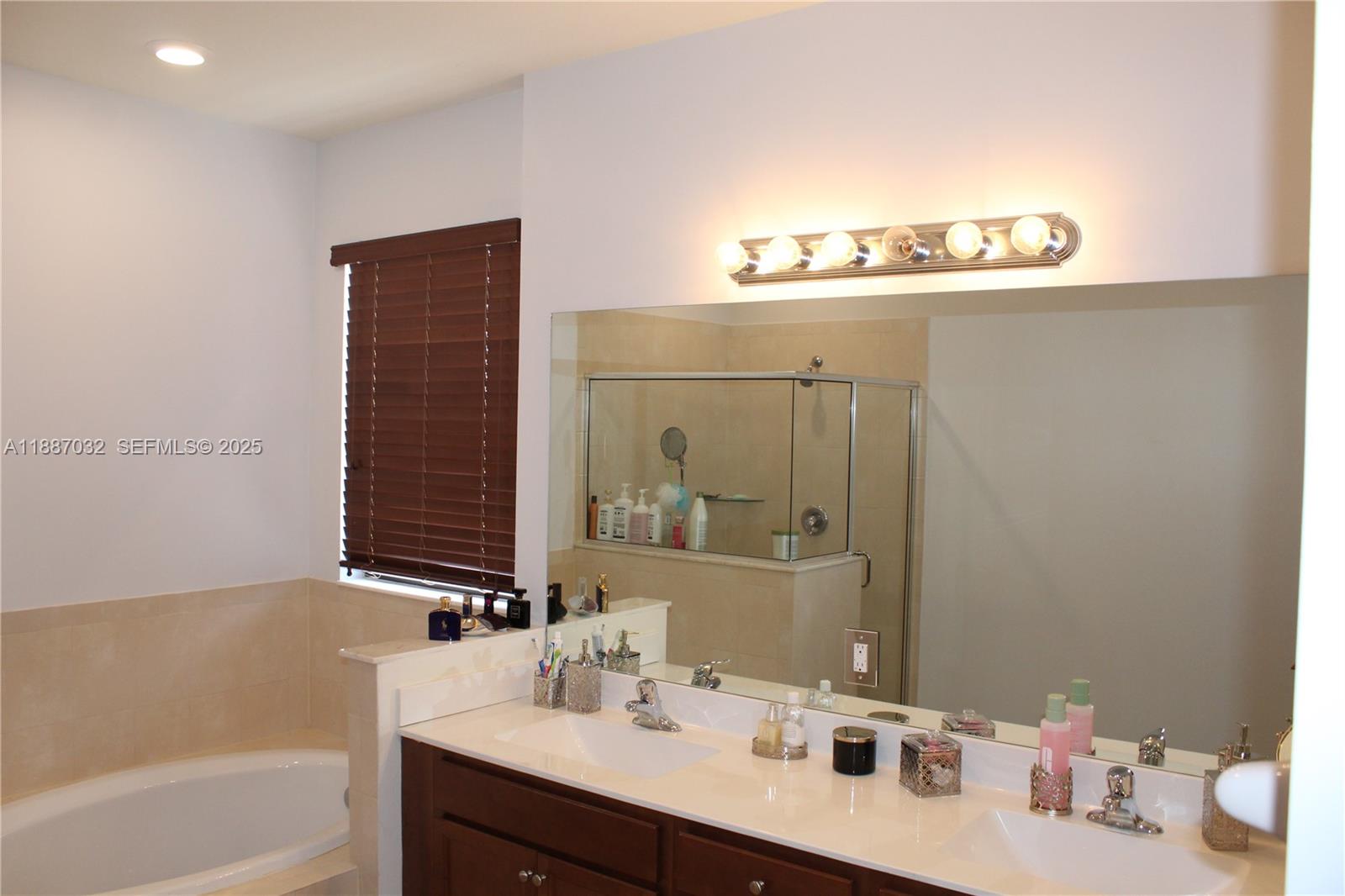 3728 Southeast 5th Court Homestead, FL 33033 - Photo 13 of 26 a bathroom with a sink and a mirror