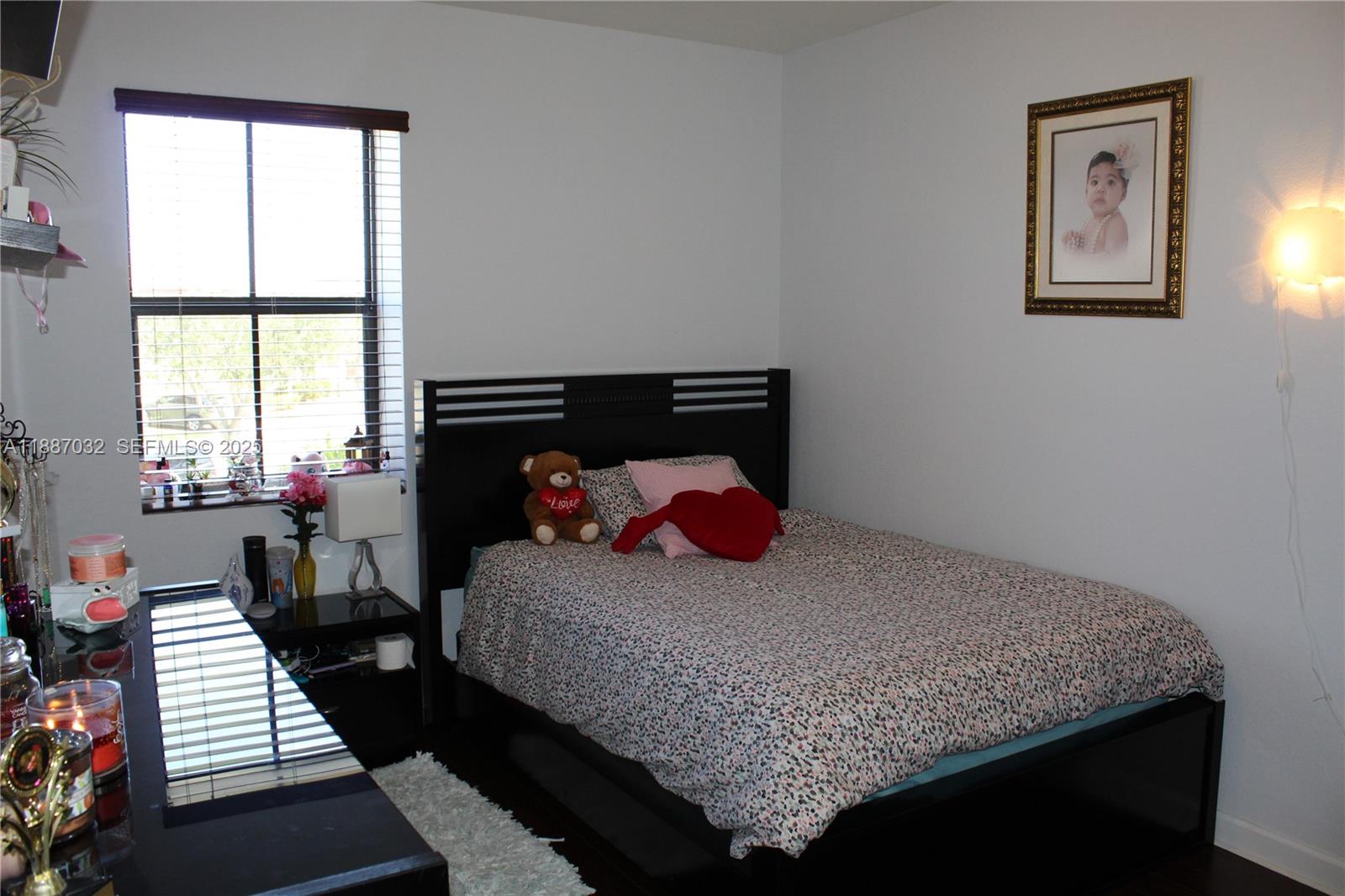 3728 Southeast 5th Court Homestead, FL 33033 - Photo 14 of 26 a bedroom with a bed and wooden floor