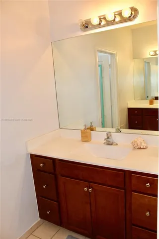a picture of a bathroom with a vanity and a shower curtain