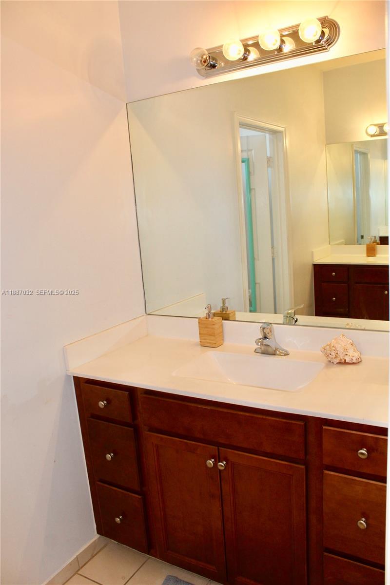 3728 Southeast 5th Court Homestead, FL 33033 - Photo 18 of 26 a bathroom with a sink and a mirror