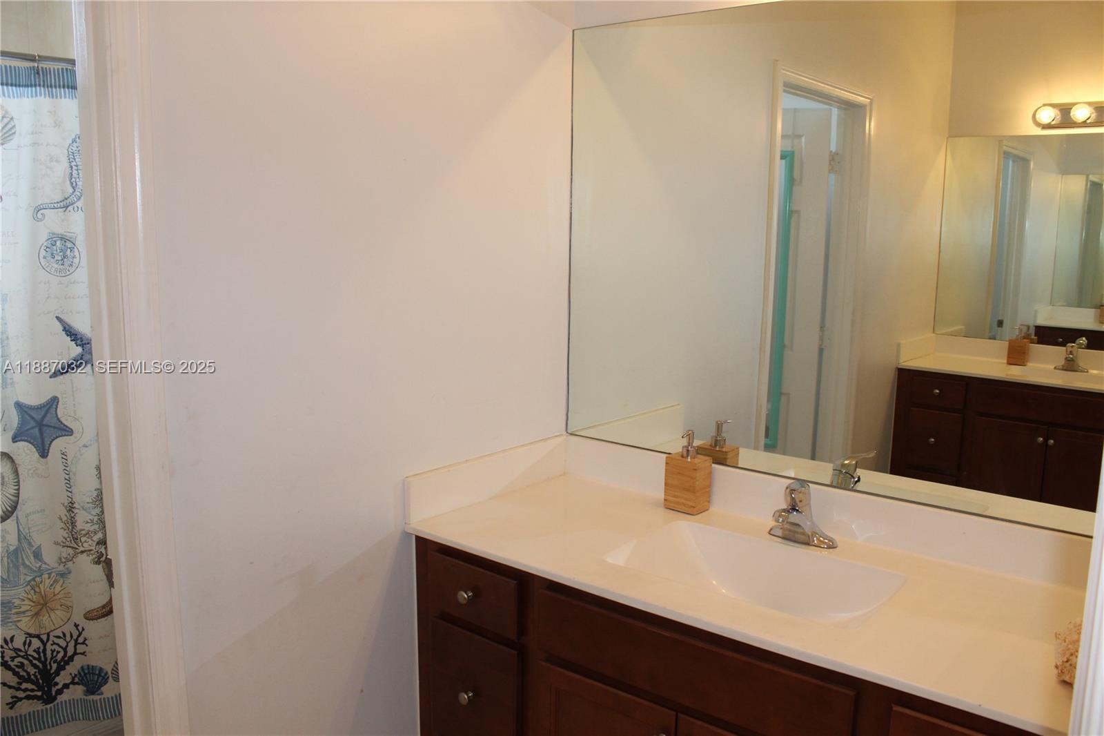 3728 Southeast 5th Court Homestead, FL 33033 - Photo 23 of 26 a bathroom with a sink and a mirror