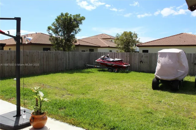 a view of a backyard with a garden and entertaining space