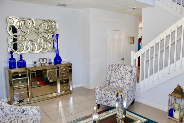 a view of a dining room with furniture a chandelier and wooden floor