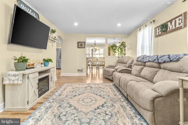 a living room with furniture fireplace and flat screen tv