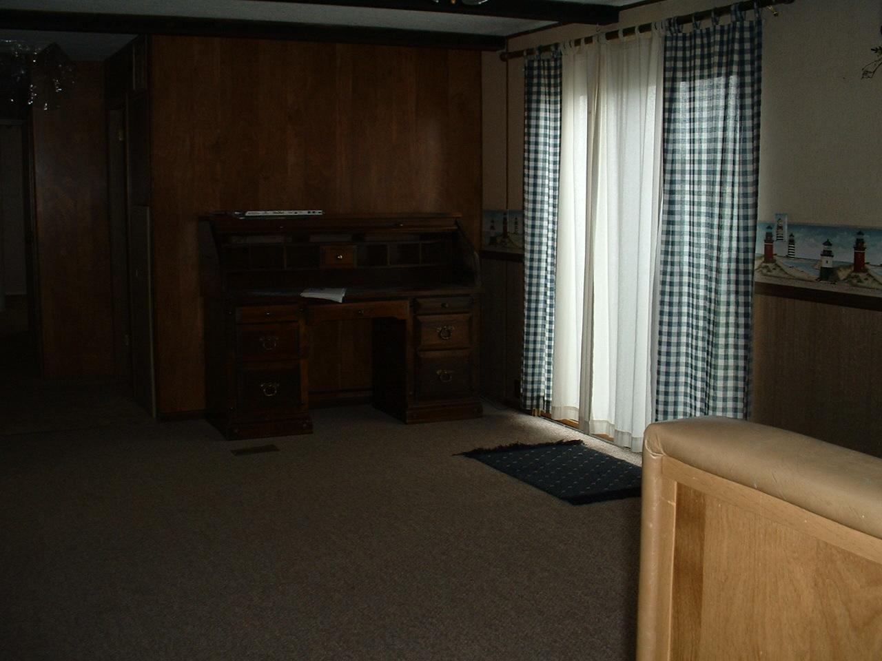 525 Rouse Road, Unit 16 Sunnyside, WA 98944 - Photo 5 of 6 a kitchen with a refrigerator and cabinets