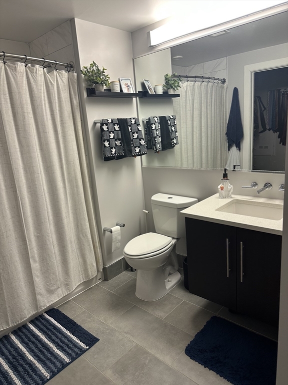 1973 Dorchester Avenue, Unit 5004 Boston, MA 02124 - Photo 12 of 15 a bathroom with a toilet a sink and a mirror