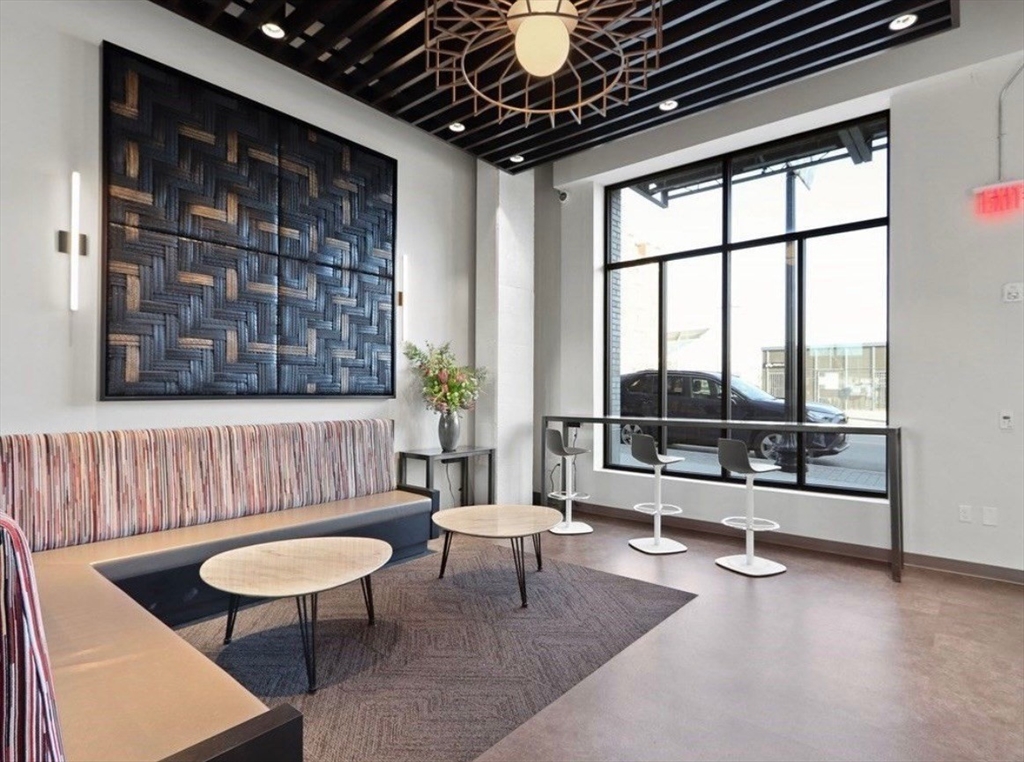 1973 Dorchester Avenue, Unit 5004 Boston, MA 02124 - Photo 3 of 15 a living room with furniture and a large window