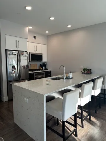 a kitchen that has a table and chairs in it