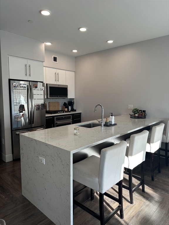 1973 Dorchester Avenue, Unit 5004 Boston, MA 02124 - Photo 5 of 15 a kitchen that has a table and chairs in it