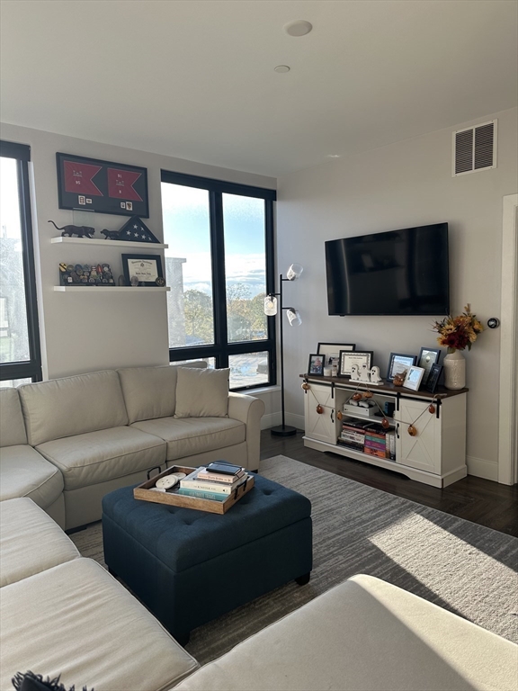 1973 Dorchester Avenue, Unit 5004 Boston, MA 02124 - Photo 7 of 15 a living room with furniture and a flat screen tv
