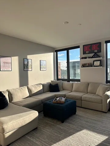 a living room with furniture and a large window