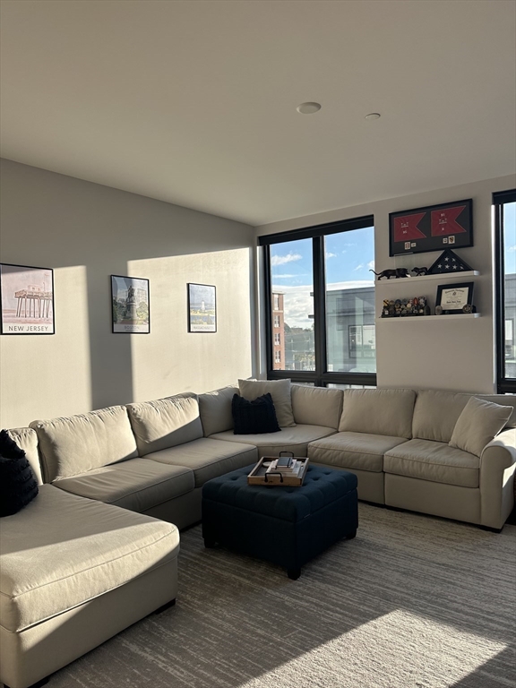 1973 Dorchester Avenue, Unit 5004 Boston, MA 02124 - Photo 8 of 15 a living room with furniture and a large window