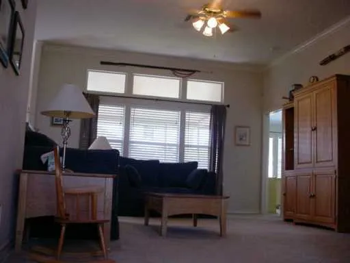 a view of a livingroom with furniture and a window