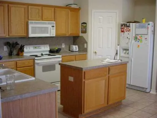 a kitchen with a sink stove and refrigerator