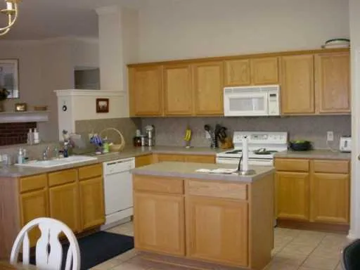 a kitchen with cabinets a sink and appliances