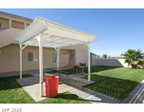 1448 Star Road, Unit 2 Pahrump, NV 89048 - Photo 10 of 10 An inviting covered patio offers shaded outdoor dining and a spacious lawn for leisure.