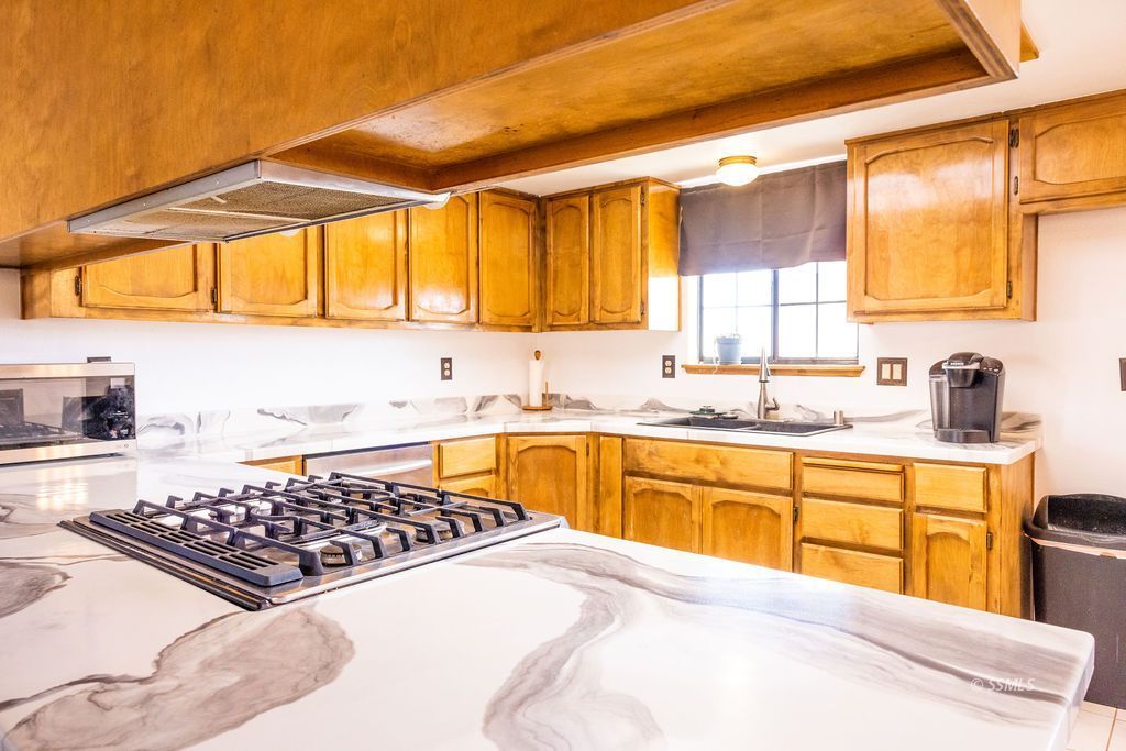 834 West Graaf Avenue Ridgecrest, CA 93555 - Photo 18 of 39 a kitchen with stainless steel appliances a sink a stove and a refrigerator