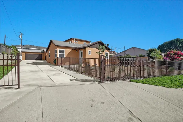 a view of a house with wooden fence