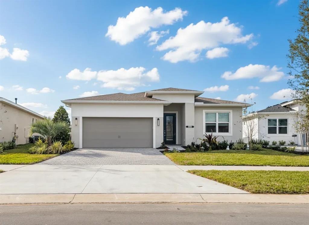 1599 Bellagio Loop Tavares, FL 32778 - Photo 1 of 1 a front view of house with yard and green space