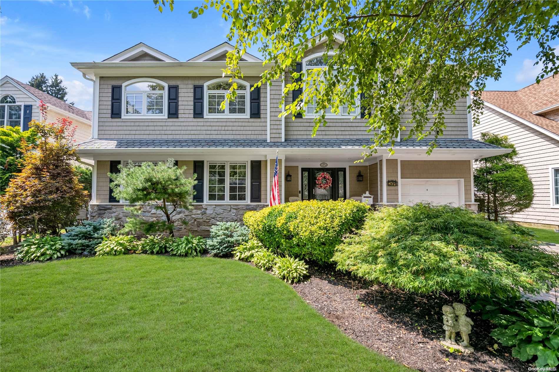 204 Kildare Road Garden City, NY 11530 - Photo 1 of 1 a front view of a house with a garden