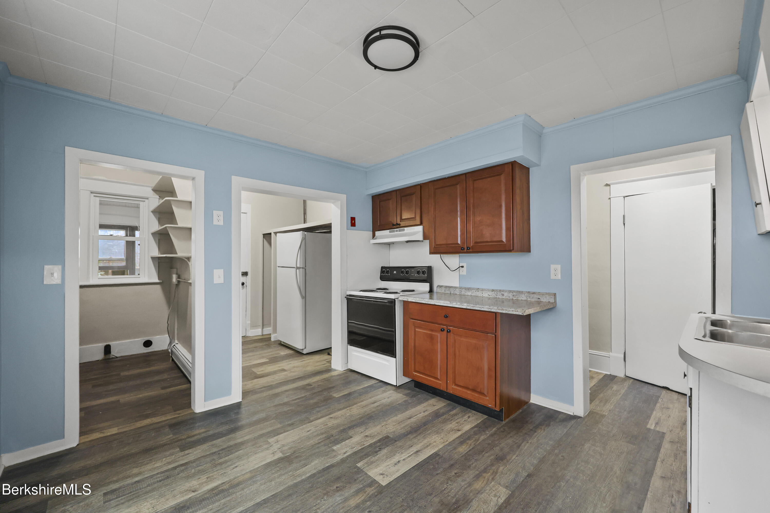 41-43 Reed Street Pittsfield, MA 01201 - Photo 11 of 56 a kitchen with granite countertop stainless steel appliances and wooden cabinets