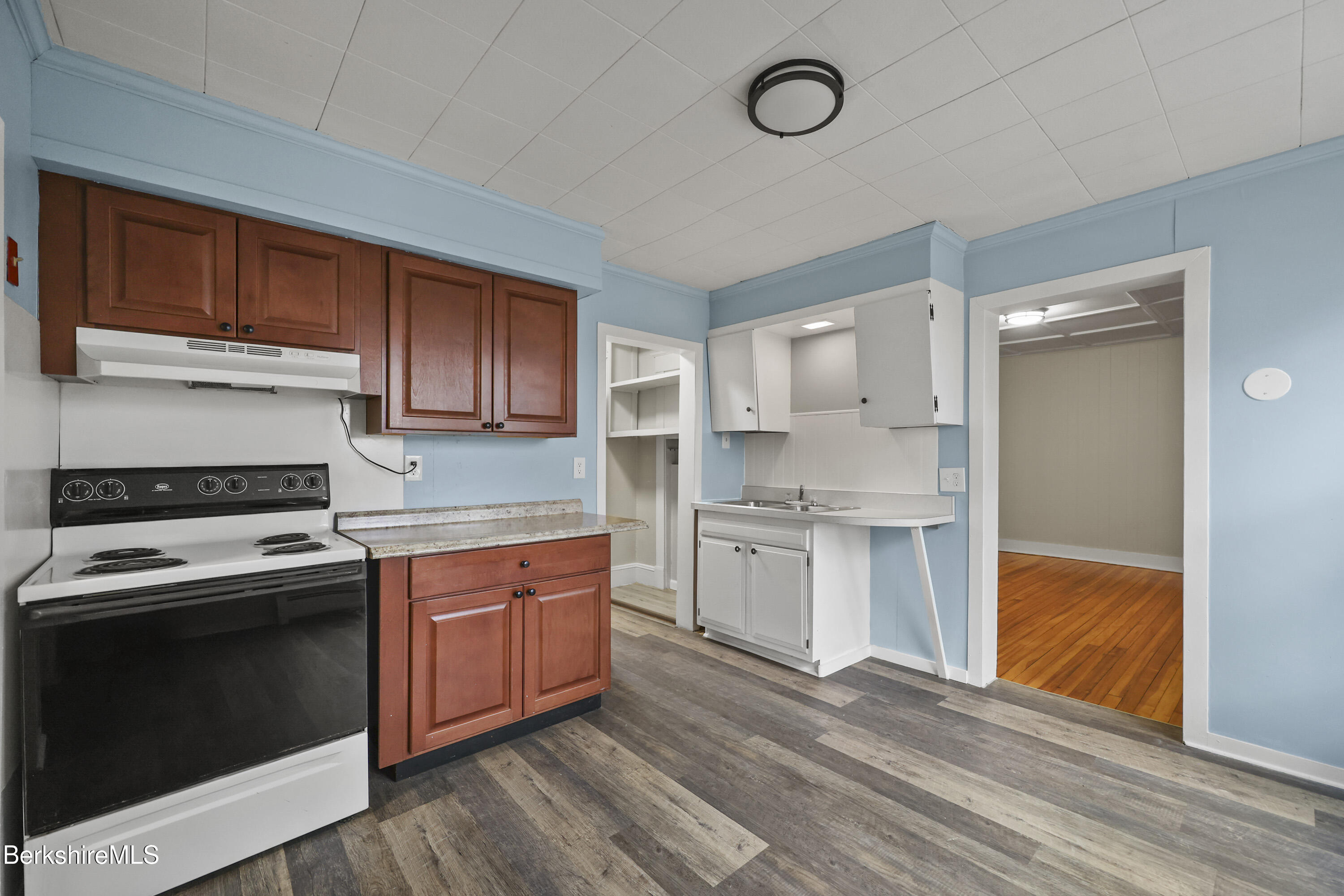 41-43 Reed Street Pittsfield, MA 01201 - Photo 12 of 56 a kitchen with a stove sink and cabinets