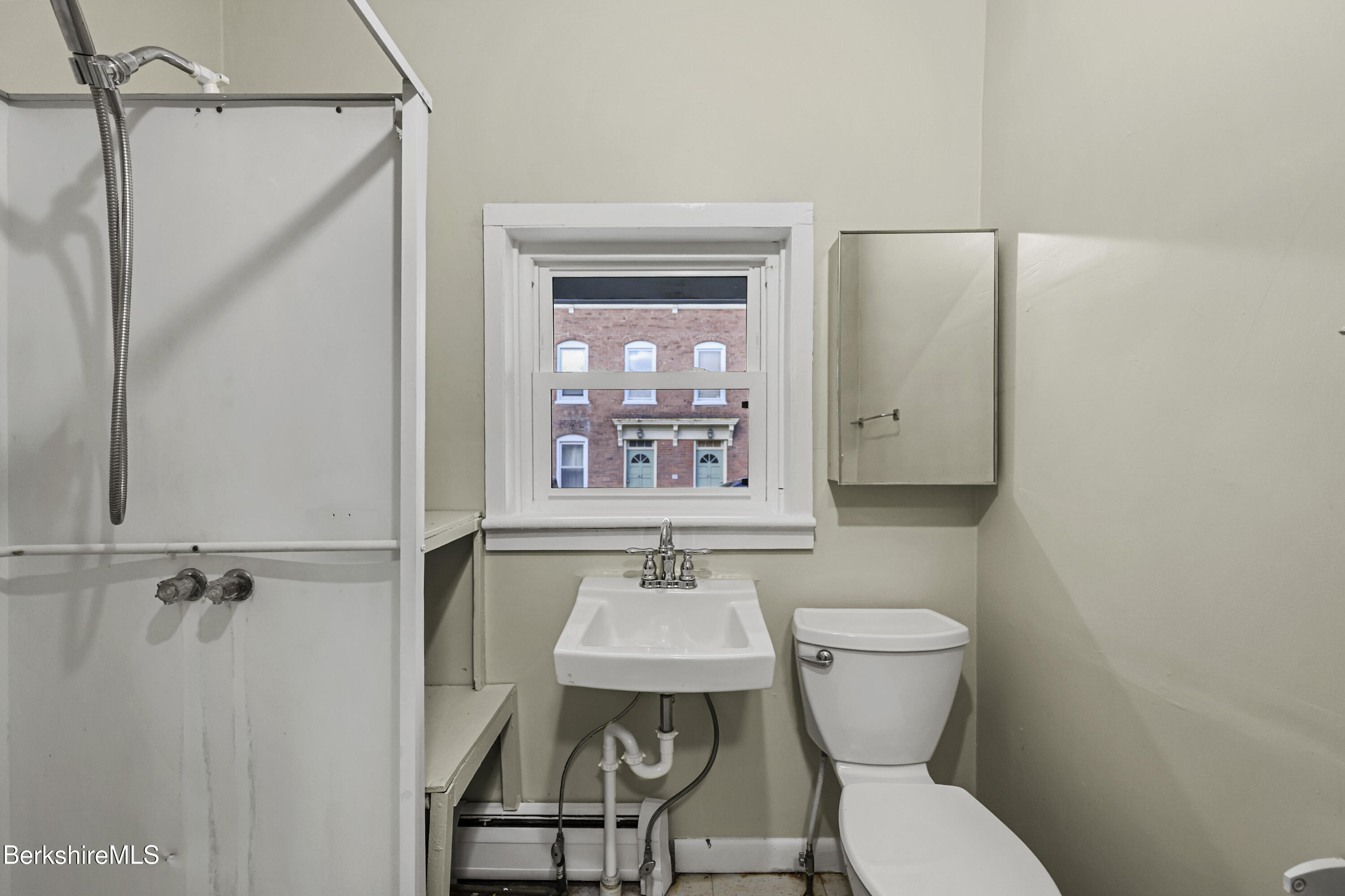 41-43 Reed Street Pittsfield, MA 01201 - Photo 25 of 56 a bathroom with a toilet a sink and a mirror